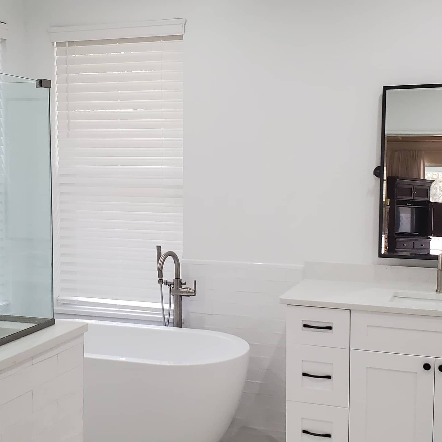 Remodeled master bathroom in Tampa Bay by Family First 365 — tile shower, new vanity, and modern fixtures.
