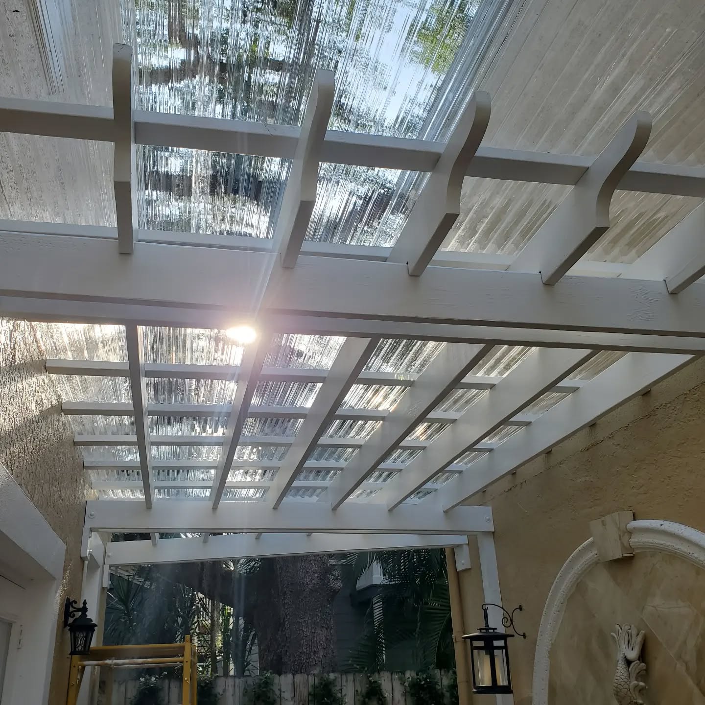 White 20 by 10 pergola with clear roof panels — outdoor living
